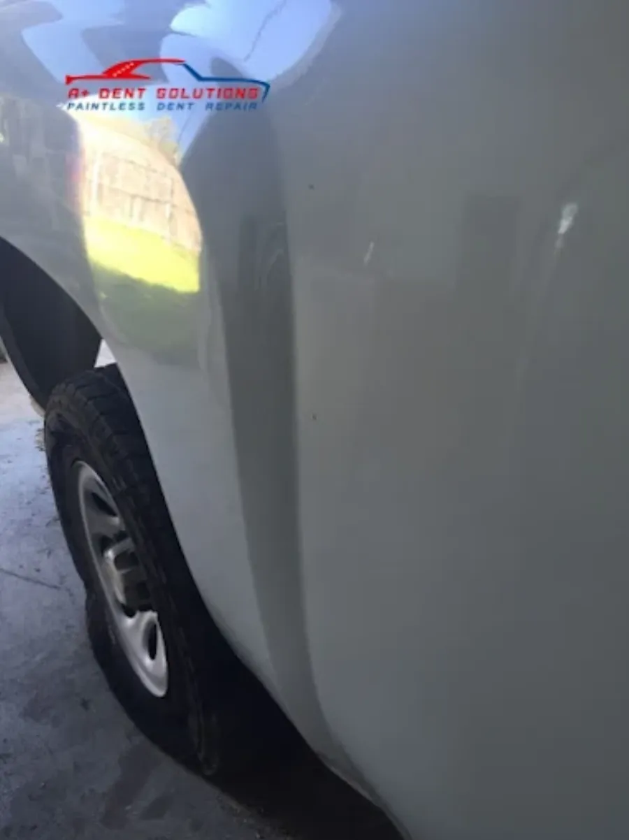 Paintless dent repair before and after on white truck panel in Garland TX