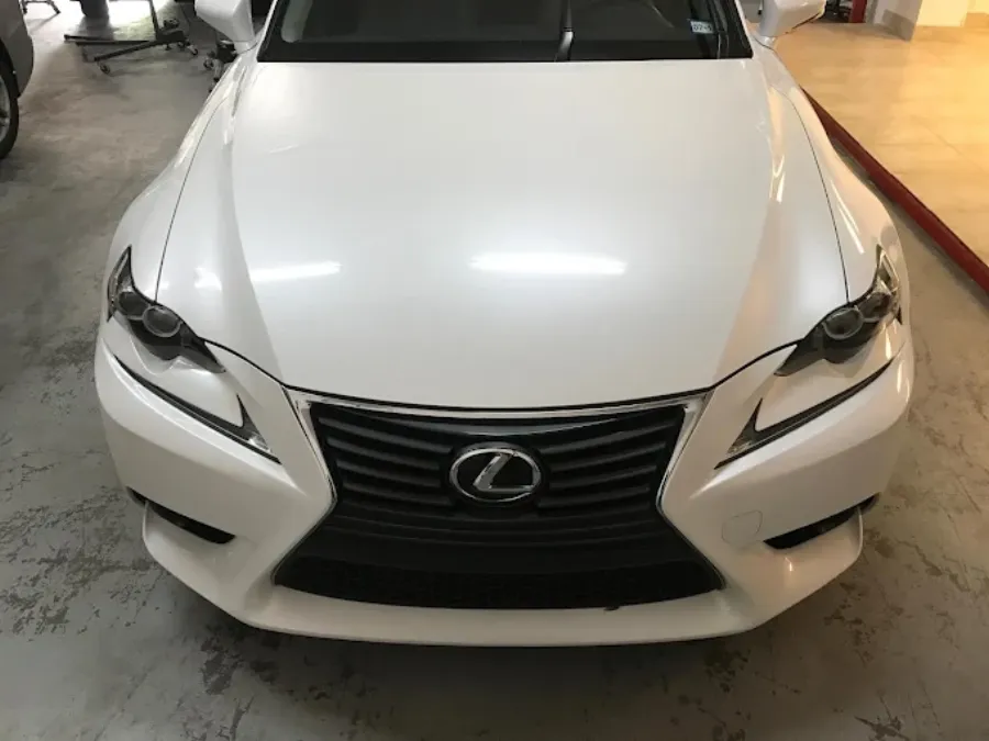 Hail damage paintless dent repair before and after on white Lexus hood in Garland TX