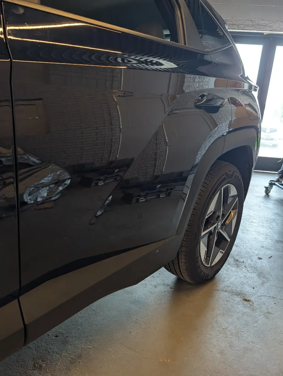 Paintless dent repair before and after on black Hyundai Tucson rear door and quarter panel in Garland TX