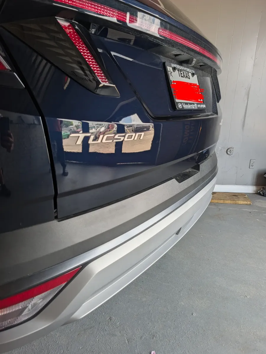 Paintless dent repair before and after on dark blue Hyundai Tucson rear tailgate in Garland TX