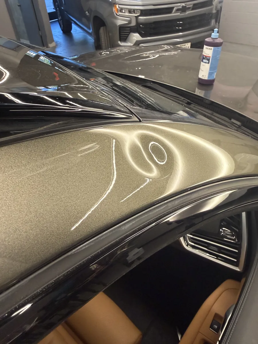 Paintless dent repair before and after on vehicle panel in Garland TX