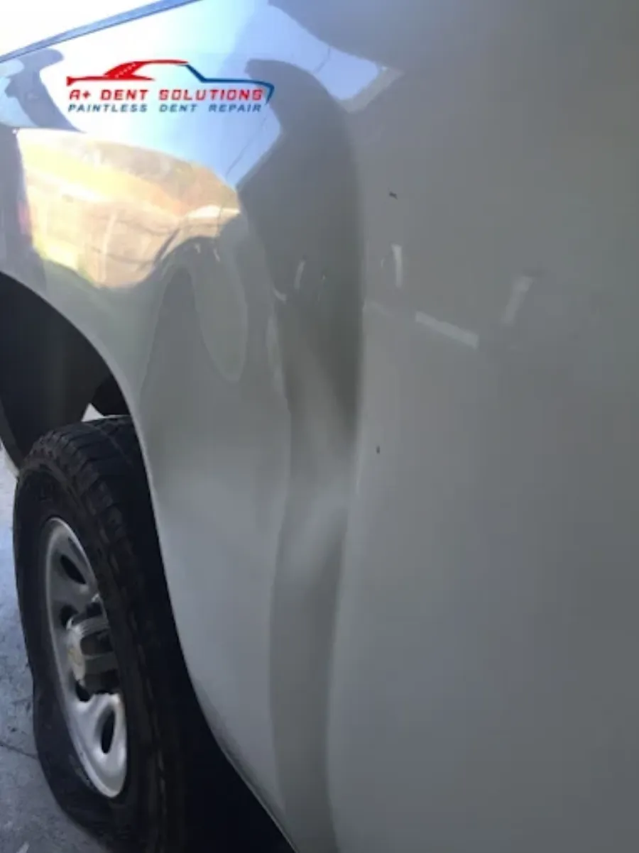 Paintless dent repair before and after on white truck panel in Garland TX