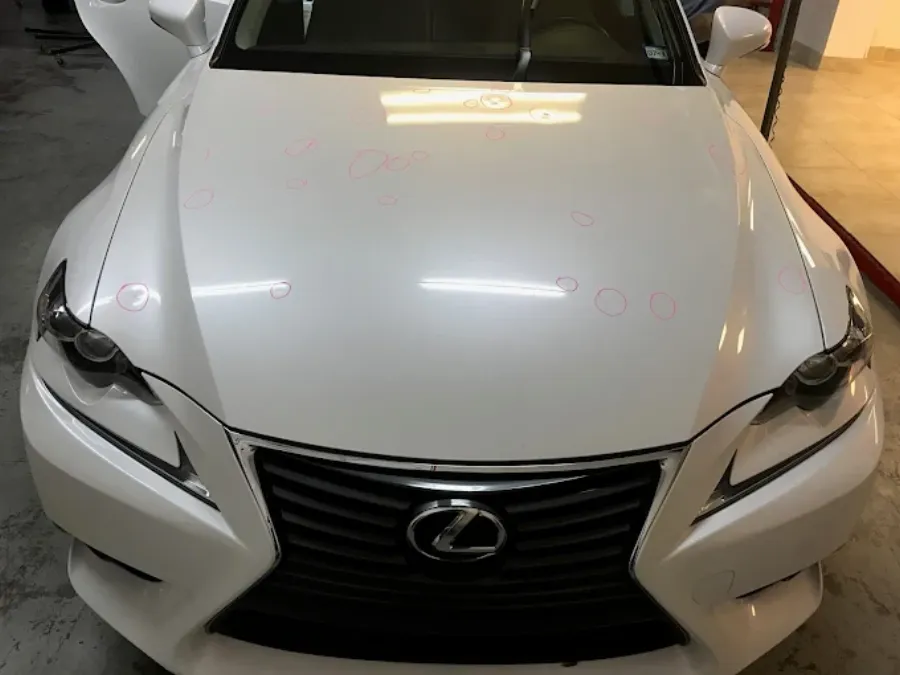 Hail damage paintless dent repair before and after on white Lexus hood in Garland TX