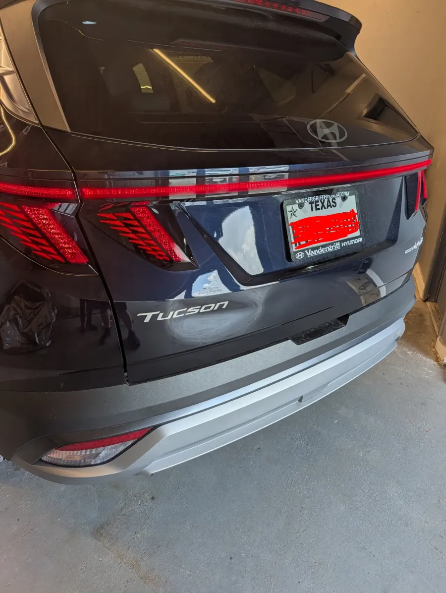 Paintless dent repair before and after on dark blue Hyundai Tucson rear tailgate in Garland TX