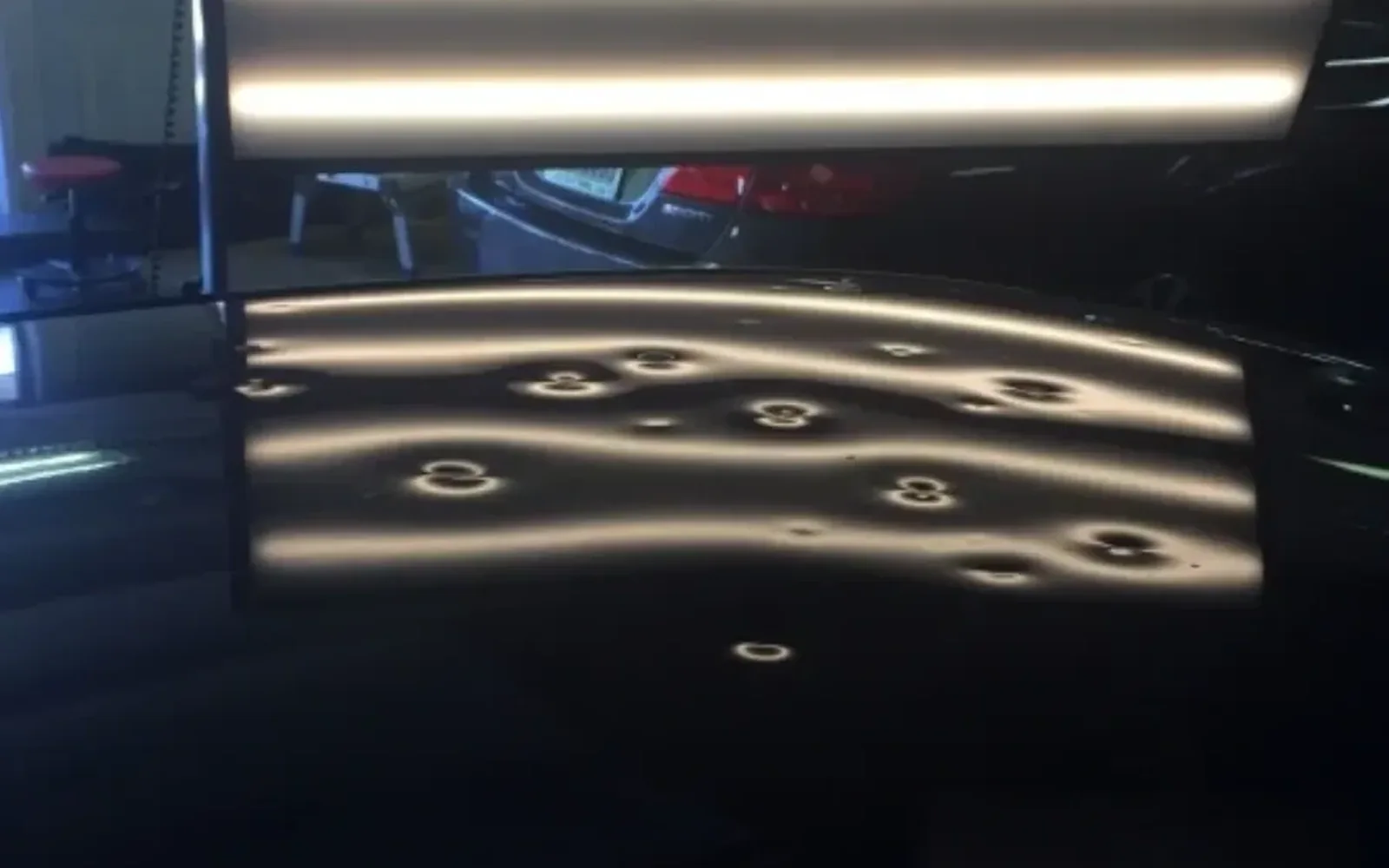 Before and after paintless dent repair on a vehicle at A+ Dent Solutions shop in Garland TX